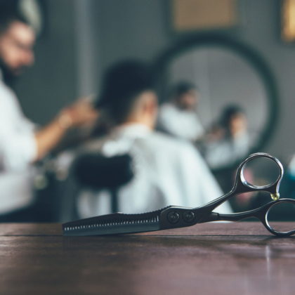 Scissors with barber in the background